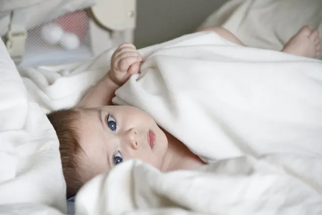 Preparing to swaddle a baby safely on a flat surface