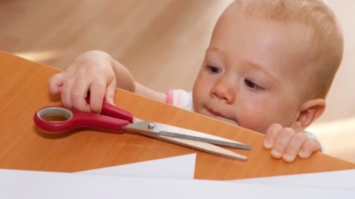 baby with scissor