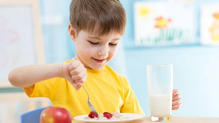 Hydration and Healthy Habits of child eating food and drink milk
